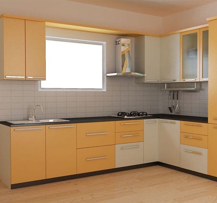 L-shape modular kitchen 6 L-shaped modular kitchen featuring a vibrant combination of mustard yellow and cream cabinetry with a sleek black countertop. The kitchen is well-lit with a large window above the sink, and the backsplash consists of neutral-toned tiles. A stainless steel chimney is mounted above the built-in gas stove, and a set of hanging kitchen utensils adds functionality. The wooden flooring complements the warm color scheme.