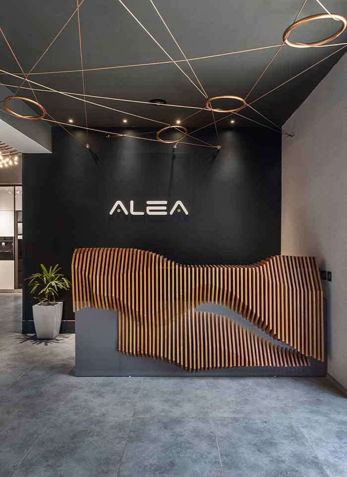 Reception desk beneath the ALEA sign at the experience centre