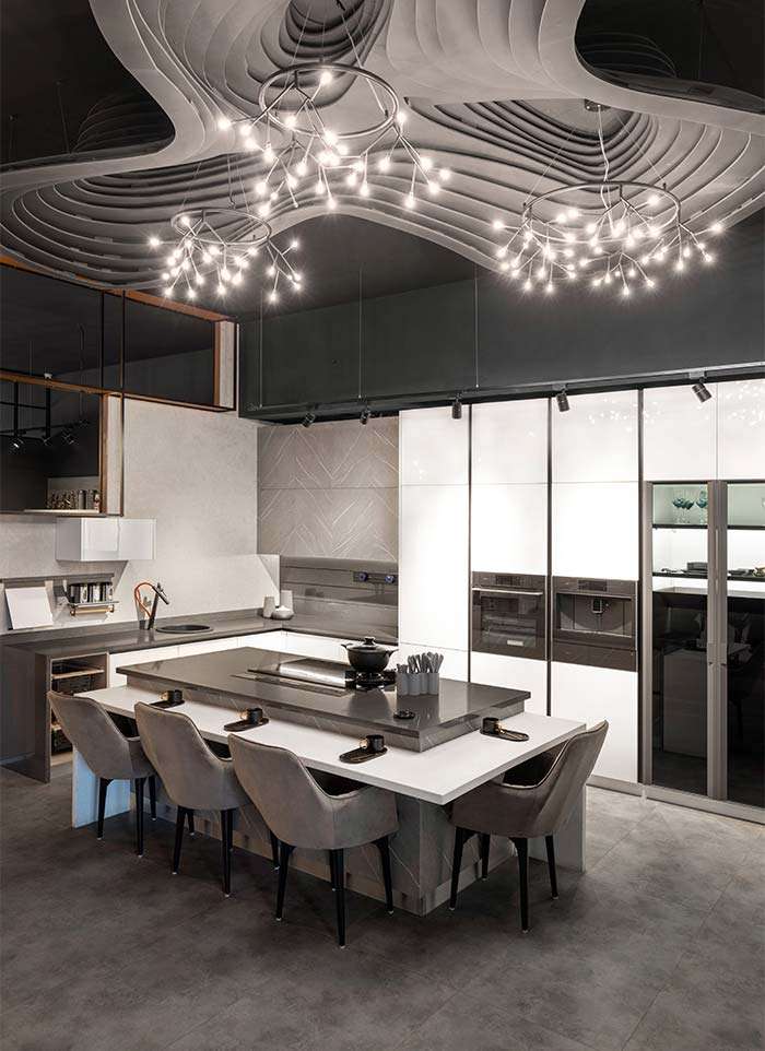 Kitchen display with an island and dining seating at the ALEA experience centre