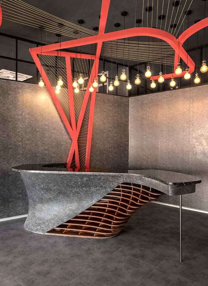 Sculpted stone counter and pendant lighting at the ALEA experience centre