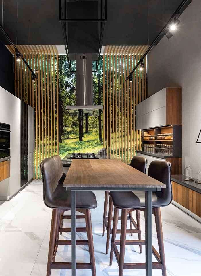 Kitchen display with a high dining table and tall units at the ALEA experience centre