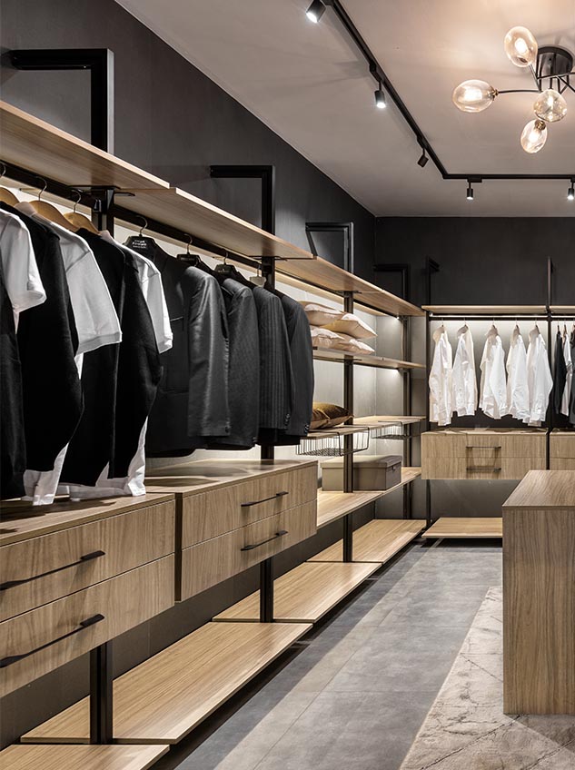 Walk in wardrobe 2 Luxury walk-in wardrobe with open wooden shelves, hanging rails, and modern lighting.