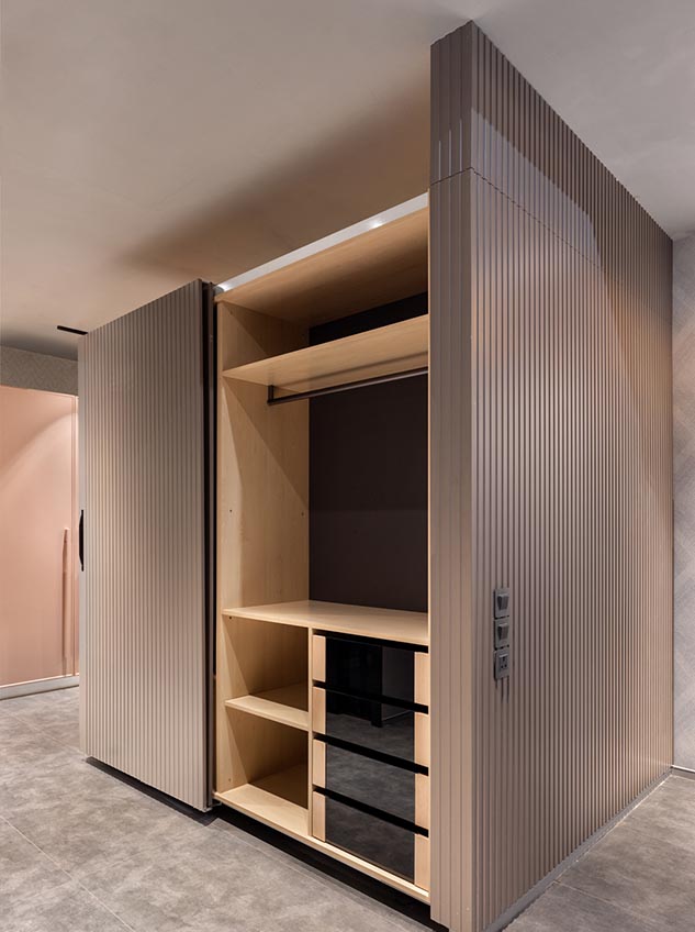 Sliding wardrobe 2 Open wardrobe with wooden shelves and vertical panelled doors.